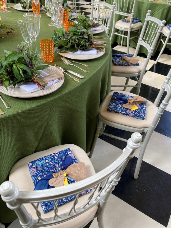 Furoshiki wrapped gifts at a corporate event. Fabric wrapped gifts are placed on each chair at a sustainable corporate event.