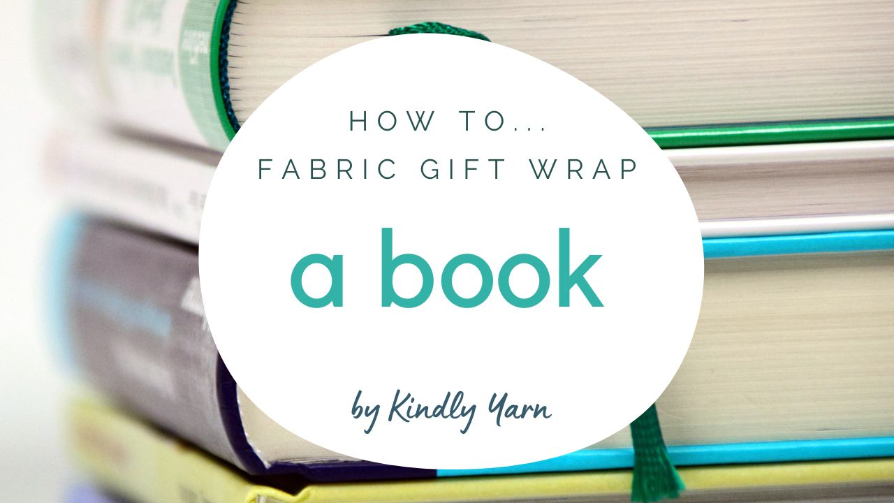 Load video: How to wrap with fabric. Wrapping a book or rectangular gift is really simple with a furoshiki fabric wrap of scarf. Watch how.